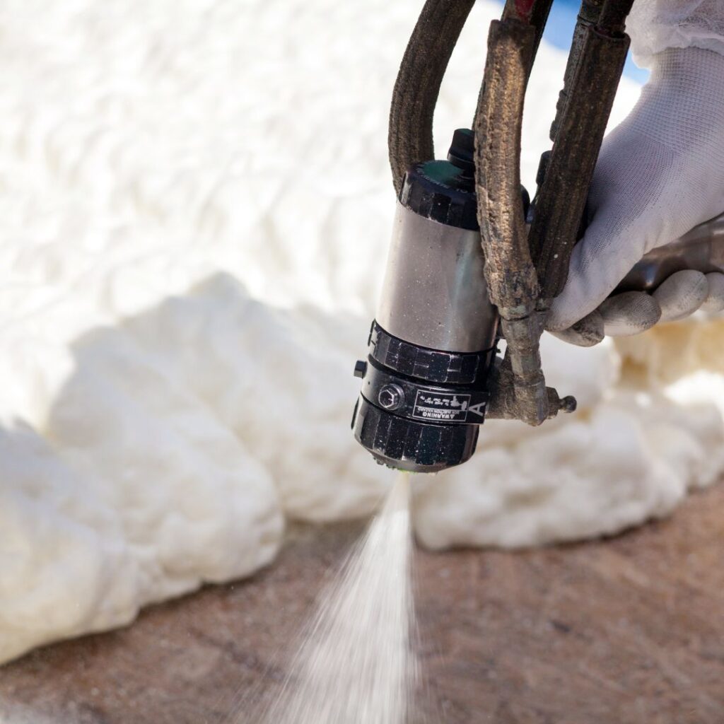 a spray foam gun being used outside