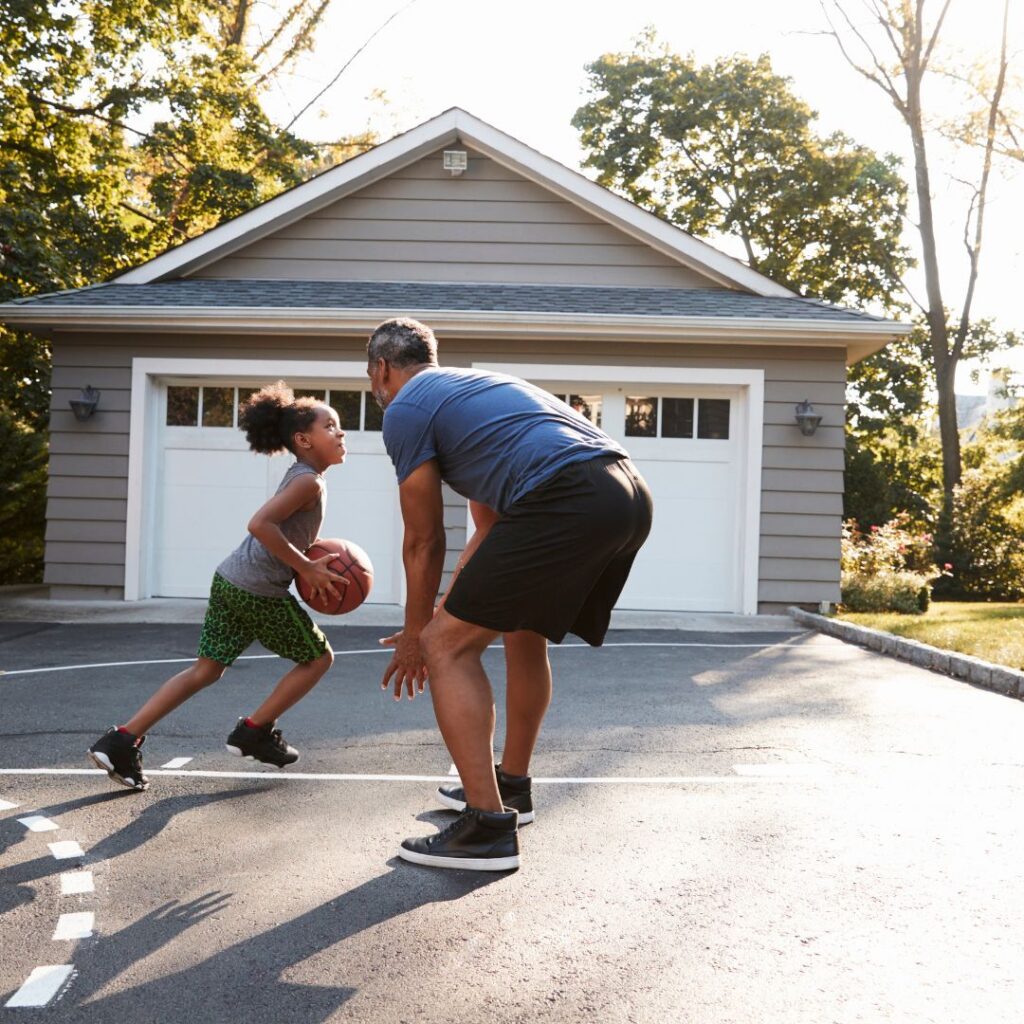 Father and daughter playing basketball
