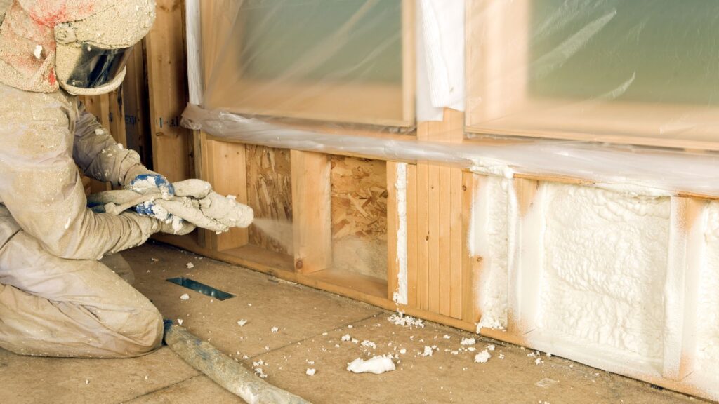Person spraying foam insulation