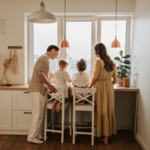 A family enjoys time together in their bright, energy-efficient kitchen, a benefit of quality home insulation.