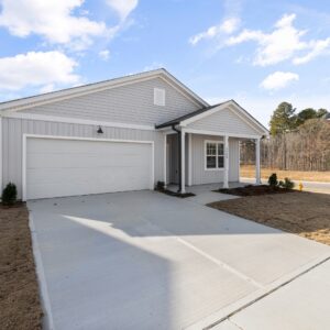 The exterior of a modern home with a clean concrete driveway, a property that benefits from Pro-Seal's services.