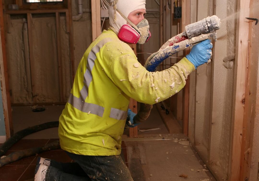 man spraying foam insullation